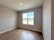 Bedroom features wood-look tile floors, neutral colored walls, and a bright window view at 2647 Sw 154Th Ln, Ocala, FL 34473
