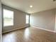 Bright bedroom with tile flooring and two windows at 2647 Sw 154Th Ln, Ocala, FL 34473