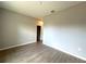 Neutral bedroom features wood-look tile flooring and access to a walk-in closet at 2647 Sw 154Th Ln, Ocala, FL 34473