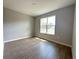Bedroom with wood-look tile floors, a window providing natural light, and neutral colored walls at 2647 Sw 154Th Ln, Ocala, FL 34473