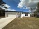 Modern single-story home featuring a two-car garage, stone accents, and well-manicured front lawn at 2647 Sw 154Th Ln, Ocala, FL 34473
