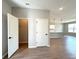 Light interior featuring closet with an open door and wood-look tile floors leading to the kitchen area at 2647 Sw 154Th Ln, Ocala, FL 34473