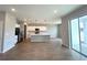 Open-concept kitchen features a large island, stainless steel appliances, white cabinetry, and modern pendant lighting at 2647 Sw 154Th Ln, Ocala, FL 34473