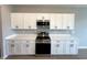 Modern kitchen with white cabinets, stainless steel appliances, and light countertops at 2647 Sw 154Th Ln, Ocala, FL 34473