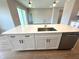 Elegant kitchen island featuring white cabinetry, stainless steel appliances, and modern faucet at 2647 Sw 154Th Ln, Ocala, FL 34473