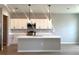 Contemporary kitchen boasting white cabinets, modern appliances, sleek countertops, and an island at 2647 Sw 154Th Ln, Ocala, FL 34473