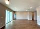 Image of a living room featuring wood-look tile flooring and sliding glass doors leading to the outside at 2647 Sw 154Th Ln, Ocala, FL 34473