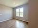 Bedroom features wood-look flooring and a window providing natural light at 3015 Sw 132Nd St, Ocala, FL 34473