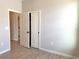 This bedroom has wood-look tile flooring and a closet with sliding doors at 3015 Sw 132Nd St, Ocala, FL 34473