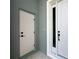 Close-up of the home's entryway, featuring a modern front door and a side door leading to the garage at 3015 Sw 132Nd St, Ocala, FL 34473