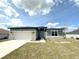 Charming single-story home featuring stone accents, a two-car garage, and a well-manicured lawn at 3015 Sw 132Nd St, Ocala, FL 34473