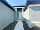 Inviting front entrance with a modern pathway and stylish exterior paint, creating a welcoming first impression at 3015 Sw 132Nd St, Ocala, FL 34473