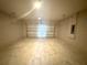 This is an empty two car garage with a concrete floor and a metal garage door at 3015 Sw 132Nd St, Ocala, FL 34473