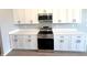 Modern kitchen featuring stainless steel appliances, white cabinets, and a tile backsplash at 3015 Sw 132Nd St, Ocala, FL 34473