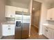 Well-lit kitchen includes stainless fridge and white cabinets at 3015 Sw 132Nd St, Ocala, FL 34473