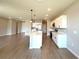 Open-concept kitchen features an island, stainless appliances, and white cabinets at 3015 Sw 132Nd St, Ocala, FL 34473