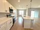 Bright kitchen features white cabinets, stainless appliances, an island and an open floor plan at 3015 Sw 132Nd St, Ocala, FL 34473