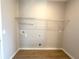 Practical laundry room with shelf, hookups, and tile flooring at 3015 Sw 132Nd St, Ocala, FL 34473
