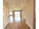Spacious living room with wood-look tile flooring and sliding glass doors leading to the lanai at 3015 Sw 132Nd St, Ocala, FL 34473
