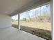 Covered back porch provides outdoor views of the landscaped backyard, perfect for relaxing at 3547 Sw 130Th Lane Rd, Ocala, FL 34473