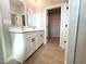 Bright bathroom featuring a double vanity and an open walk-in closet at 3547 Sw 130Th Lane Rd, Ocala, FL 34473