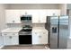 Well-equipped kitchen with stainless steel appliances and white cabinets at 3547 Sw 130Th Lane Rd, Ocala, FL 34473