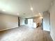 Open-concept living area with tile flooring and recessed lighting, leading to the kitchen and patio doors at 3547 Sw 130Th Lane Rd, Ocala, FL 34473