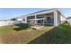 Backyard view showing home, screened porch, and play area at 6200 Sw 72Nd Ter, Ocala, FL 34474