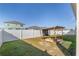 Grass backyard with sandbox, climbing dome and white fence at 6200 Sw 72Nd Ter, Ocala, FL 34474