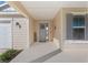 Inviting front entry with gray door, welcome sign, and gray shutters at 6200 Sw 72Nd Ter, Ocala, FL 34474