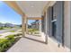 Front porch with columns, gray shutters, and view of the neighborhood at 6200 Sw 72Nd Ter, Ocala, FL 34474