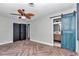 Bedroom with herringbone floors and teal barn door at 812 Se 23Rd St, Ocala, FL 34471