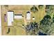 Aerial view showing multiple barns and paddocks on a large equestrian property at 10555 W Highway 40, Ocala, FL 34482