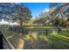 Large grassy paddock with wooden fence at 10555 W Highway 40, Ocala, FL 34482