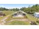 White barn with metal roof and covered porch at 10555 W Highway 40, Ocala, FL 34482