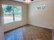 Bright bedroom with herringbone flooring and natural light from two windows at 14319 Se 26Th Ter, Summerfield, FL 34491
