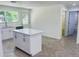 Bright kitchen with granite countertops, island, stainless appliances and backyard views at 14319 Se 26Th Ter, Summerfield, FL 34491