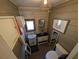Compact bathroom featuring a vanity, toilet, and decorative wall art at 14830 Se 61St Street Rd, Ocklawaha, FL 32179