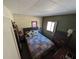 Cozy bedroom featuring rustic walls, a comfortable bed, and warm natural lighting at 14830 Se 61St Street Rd, Ocklawaha, FL 32179