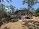Charming home featuring a large deck, lush landscaping, and a cozy, inviting atmosphere, perfect for outdoor living at 14830 Se 61St Street Rd, Ocklawaha, FL 32179