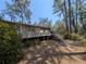 Large exterior deck providing ample space for outdoor dining and relaxation amongst mature trees at 14830 Se 61St Street Rd, Ocklawaha, FL 32179