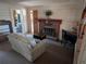 Comfortable living room featuring fireplace and views to the bathroom and another living space at 14830 Se 61St Street Rd, Ocklawaha, FL 32179