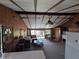 Spacious living room features wood paneling, beamed ceilings, comfortable seating, and access to outdoor patio at 14830 Se 61St Street Rd, Ocklawaha, FL 32179