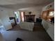 Bright living room with a brick fireplace, tile flooring, and partially opened to a bathroom at 14830 Se 61St Street Rd, Ocklawaha, FL 32179