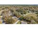 Community aerial view featuring tree-lined streets and homes nestled among the trees, creating a serene environment at 19009 Sw 98Th Loop, Dunnellon, FL 34432