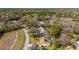 Aerial view of the neighborhood featuring well-maintained homes with screened-in pools and beautiful landscaping at 19009 Sw 98Th Loop, Dunnellon, FL 34432