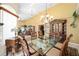 Bright dining area showcasing a glass-top table, ornate chairs, and decorative accents at 19009 Sw 98Th Loop, Dunnellon, FL 34432