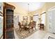 Elegant dining room featuring a glass table, ornate chairs, and a decorative hutch at 19009 Sw 98Th Loop, Dunnellon, FL 34432