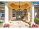 Charming home entrance with decorative columns and a welcoming bench seating at 19009 Sw 98Th Loop, Dunnellon, FL 34432