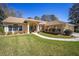 Well-maintained home featuring a lush lawn and inviting walkway to the front entrance at 19009 Sw 98Th Loop, Dunnellon, FL 34432